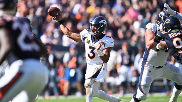 Oct 1, 2023; Chicago, Illinois, USA; Denver Broncos quarterback Russell Wilson (3) throws a touchdown pass in the fourth quarter against the Chicago Bears at Soldier Field.